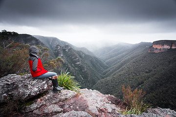 Image showing Bushwalker admires winterviews mountain wilderness as fog and cl