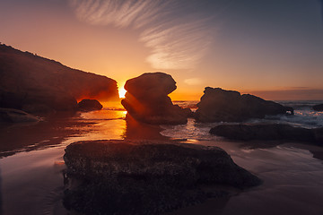 Image showing Sun rising behind coastal boulders on the magnificent rocky coastline Australia