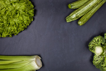 Image showing Green organic vegetables on blackboard background.