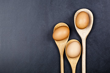 Image showing Eggs in wooden spoons.