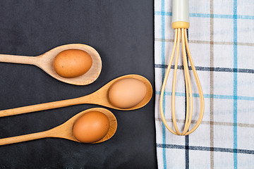 Image showing Eggs and kitchen utensil on backboard background.