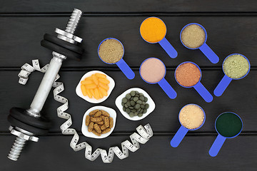 Image showing Body Building Food Supplement Powders and Dumbbells 