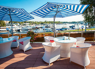 Image showing table with armchairs under a sun umbrella