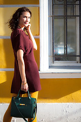 Image showing smiling middle-aged woman in a burgundy dress