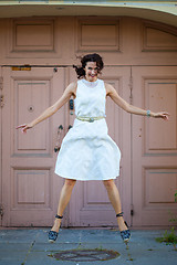 Image showing woman in a white dress hovers above the ground