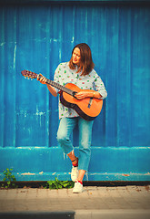 Image showing Beautiful middle aged woman with a guitar