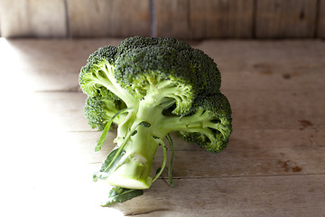 Image showing Fresh green organic broccoli on wooden rustic background.