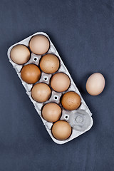 Image showing Farm chicken eggs in cardboard container.