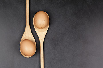 Image showing Eggs in wooden spoons. Kitchen utensil for cake, pastry or cooki