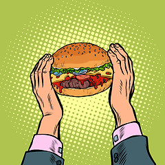 Image showing hands holding a Burger. fast food restaurant