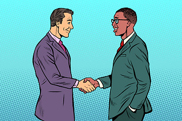 Image showing African and Caucasian businessmen men handshake