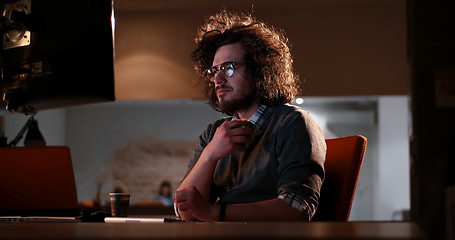 Image showing man working on computer in dark office