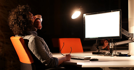 Image showing man working on computer in dark office