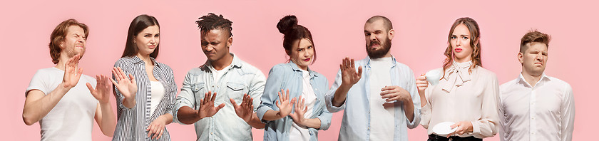 Image showing Let me think. Doubtful pensive women and men with thoughtful expression making choice against pink background