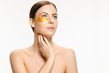 Image showing Beauty portrait of an attractive girl with a gold patch under the eye.