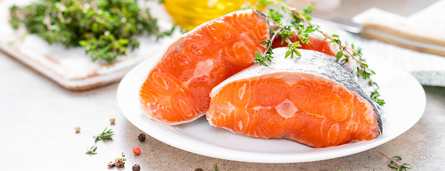 Image showing Fresh raw salmon fish steaks on white kitchen background. Banner