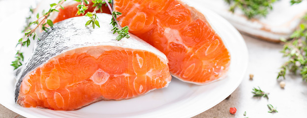 Image showing Fresh raw salmon fish steaks on white kitchen background. Banner