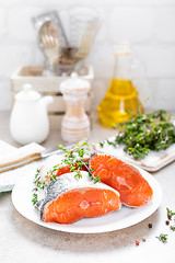 Image showing Fresh raw salmon fish steaks on white kitchen background