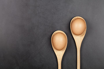 Image showing Fresh chicken eggs in wooden spoons.