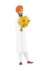 Image showing Hindu businessman holding bouquet of flowers.