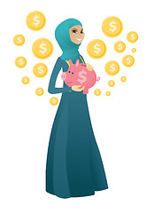 Image showing Muslim business woman holding a piggy bank.