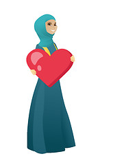 Image showing Muslim business woman holding a big red heart.