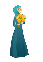 Image showing Muslim business woman holding bouquet of flowers.