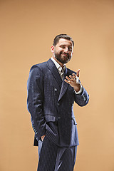 Image showing The happy business man standing and smiling against pastel background.