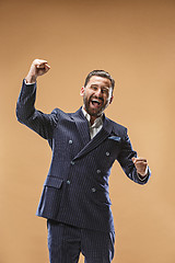 Image showing Winning success man happy ecstatic celebrating being a winner. Dynamic energetic image of male model