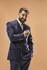 Image showing The happy business man standing and smiling against pastel background.