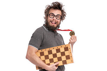 Image showing Crazy bearded man with Chess board