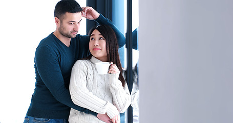 Image showing multiethnic couple relaxing at modern home indoors