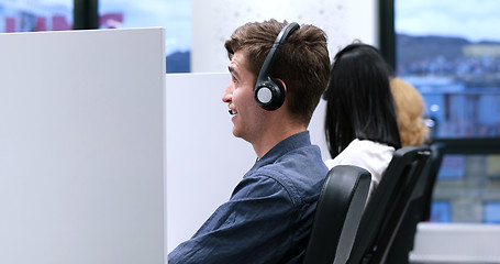 Image showing male call centre operator doing his job