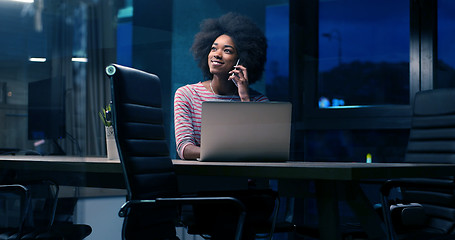 Image showing black businesswoman using a laptop in night startup office