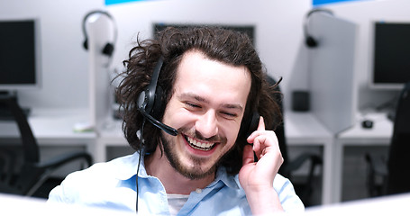 Image showing male call centre operator doing his job