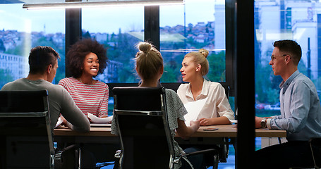 Image showing Multiethnic startup business team in night office