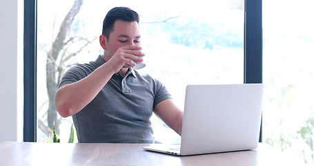 Image showing businessman working using a laptop in startup office