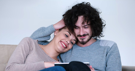 Image showing couple relaxing at  home with tablet computers