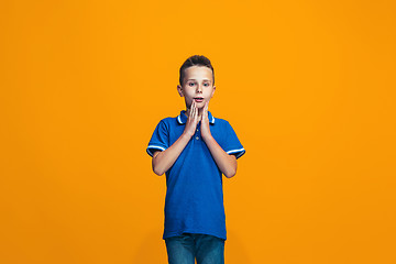 Image showing Beautiful teen boyl looking suprised isolated on orange