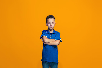 Image showing Young serious thoughtful teen boy. Doubt concept.