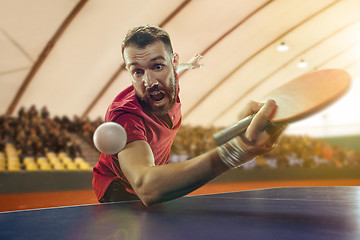 Image showing The table tennis player serving