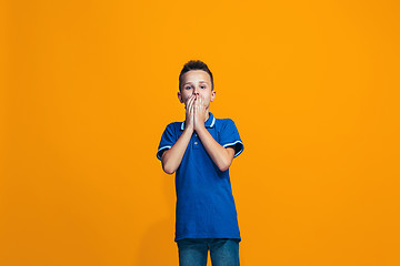 Image showing Beautiful teen boyl looking suprised isolated on orange