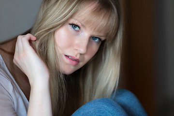 Image showing Sad girl is sitting on the floor