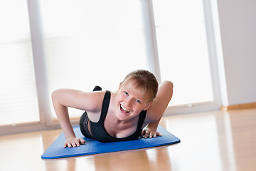 Image showing Girl doing pushups exercises