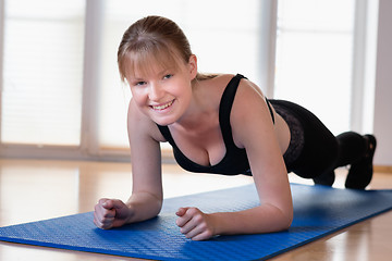 Image showing Girl doing plank exercises