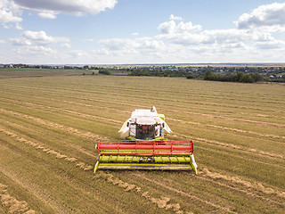 Image showing Agricultural machinery on a a farm land after harvesting in asum