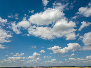 Image showing Cloudy aerial landscape with white clouds on a blue sky background. Aerial view from drone.