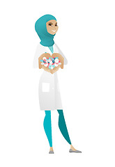 Image showing Young muslim pharmacist giving pills.