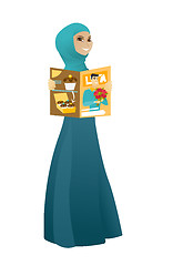 Image showing Successful muslim business woman reading magazine.