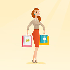 Image showing Young happy caucasian woman with shopping bags.